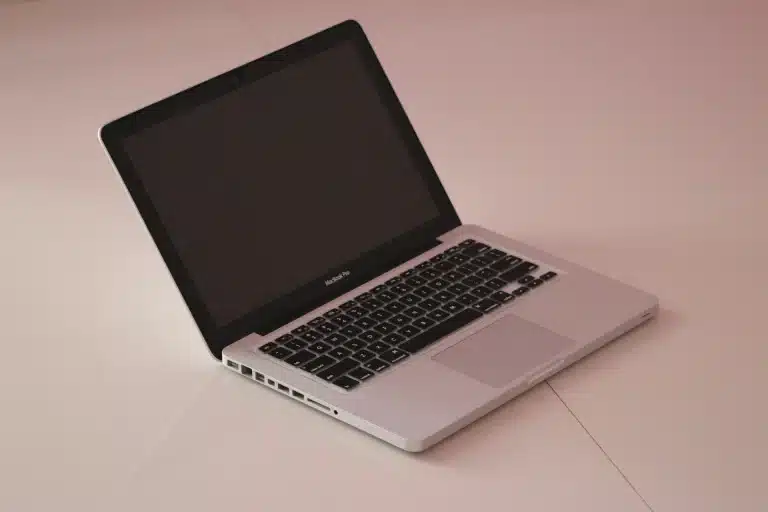 MacBook won't turn on — dark MacBook screen with charger plugged in, 2026 fixes guide